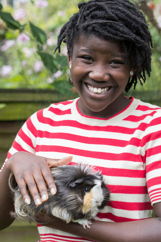 Girl holding guinea pig